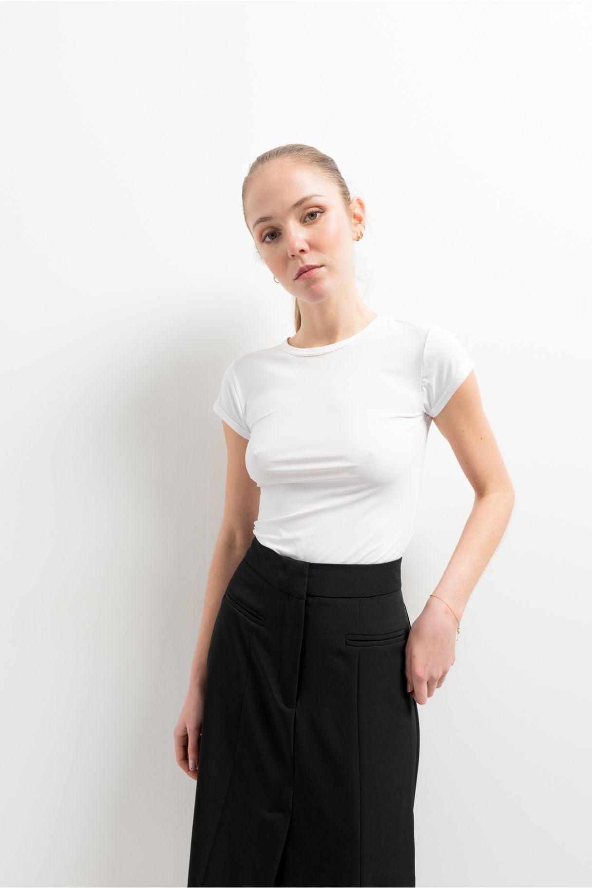 Falda midi de tubo elástica en color negro con abertura lateral en el bajo
