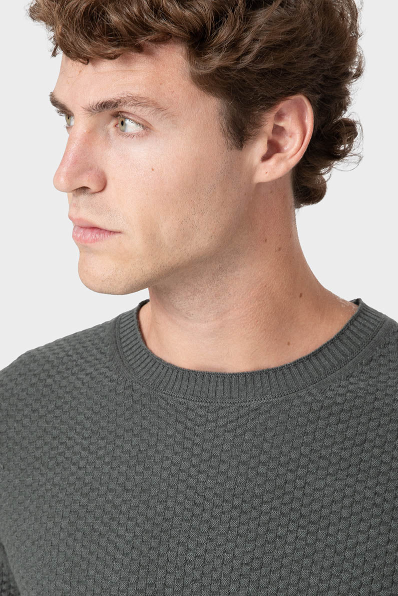 Jersey verde de algodón con textura de ladrillo