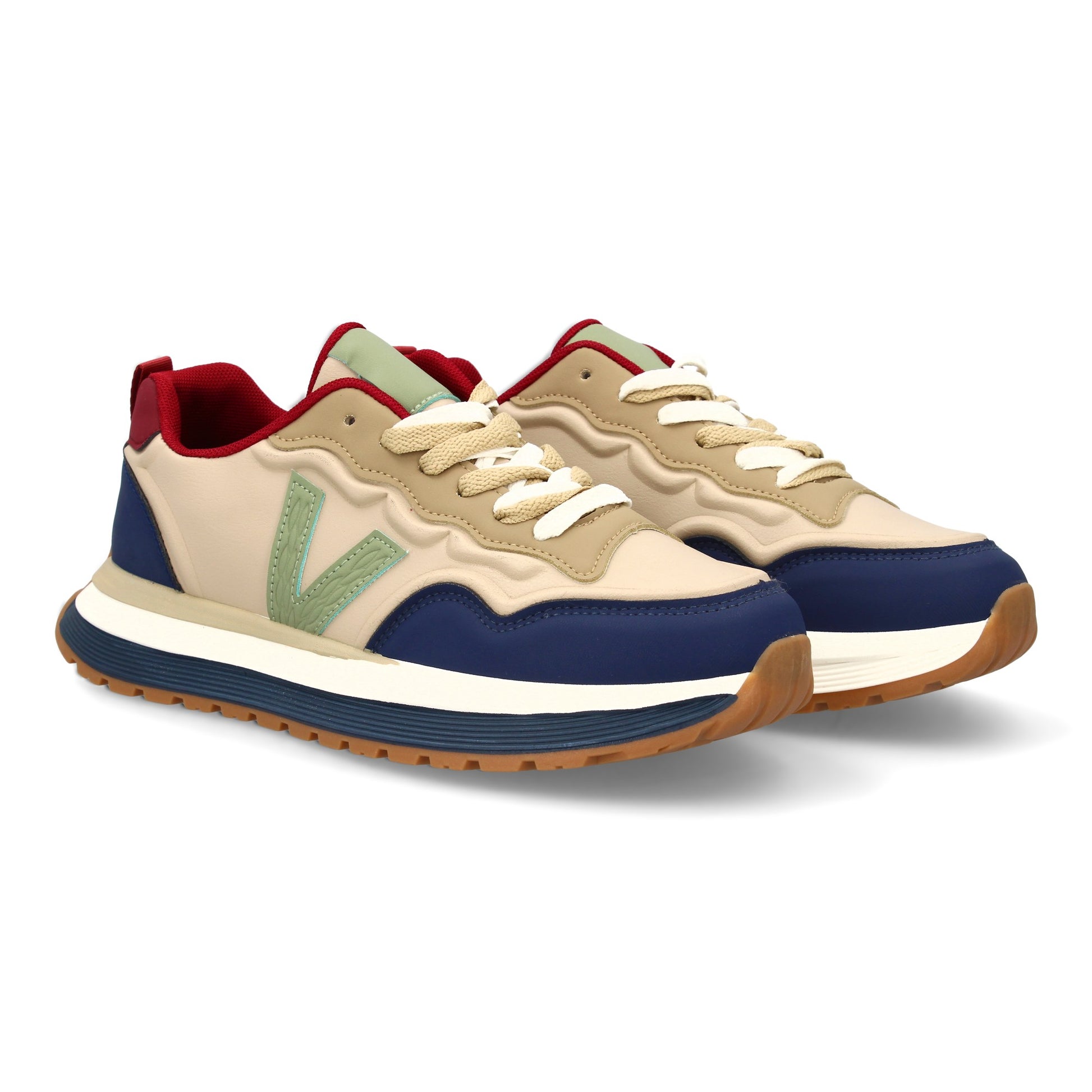 Zapatilla deportiva de hombre azul con suela dentada y cierre de cremallera.