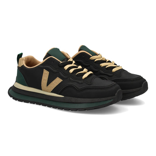 Zapatilla deportiva de hombre negra con suela dentada y cierre de cremallera.