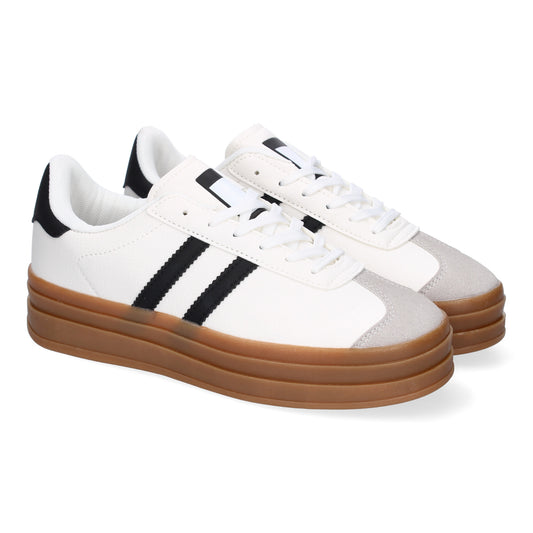 Zapatilla deportiva blanca de mujer con doble suela, elegante y moderna.