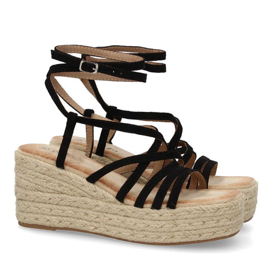 Sandalias de cuña de yute negras para mujer con tiras cruzadas y cierre de hebilla.
