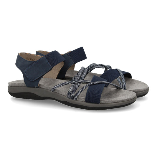 Sandalias planas de mujer color marino, con tiras elásticas cruzadas y cierre de velcro.