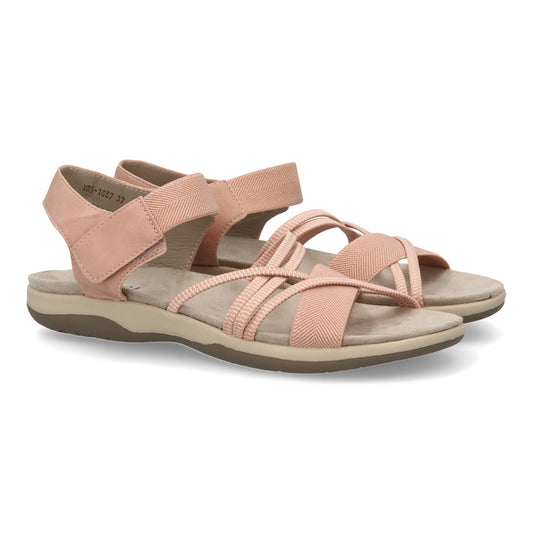 Sandalias planas de mujer color nude, con tiras elásticas cruzadas y cierre de velcro.